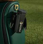 Golf ball cleaner clipped to a golf bag on the course